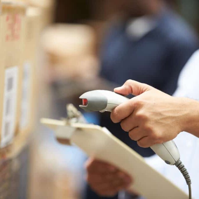 Worker Scanning Package In Warehouse